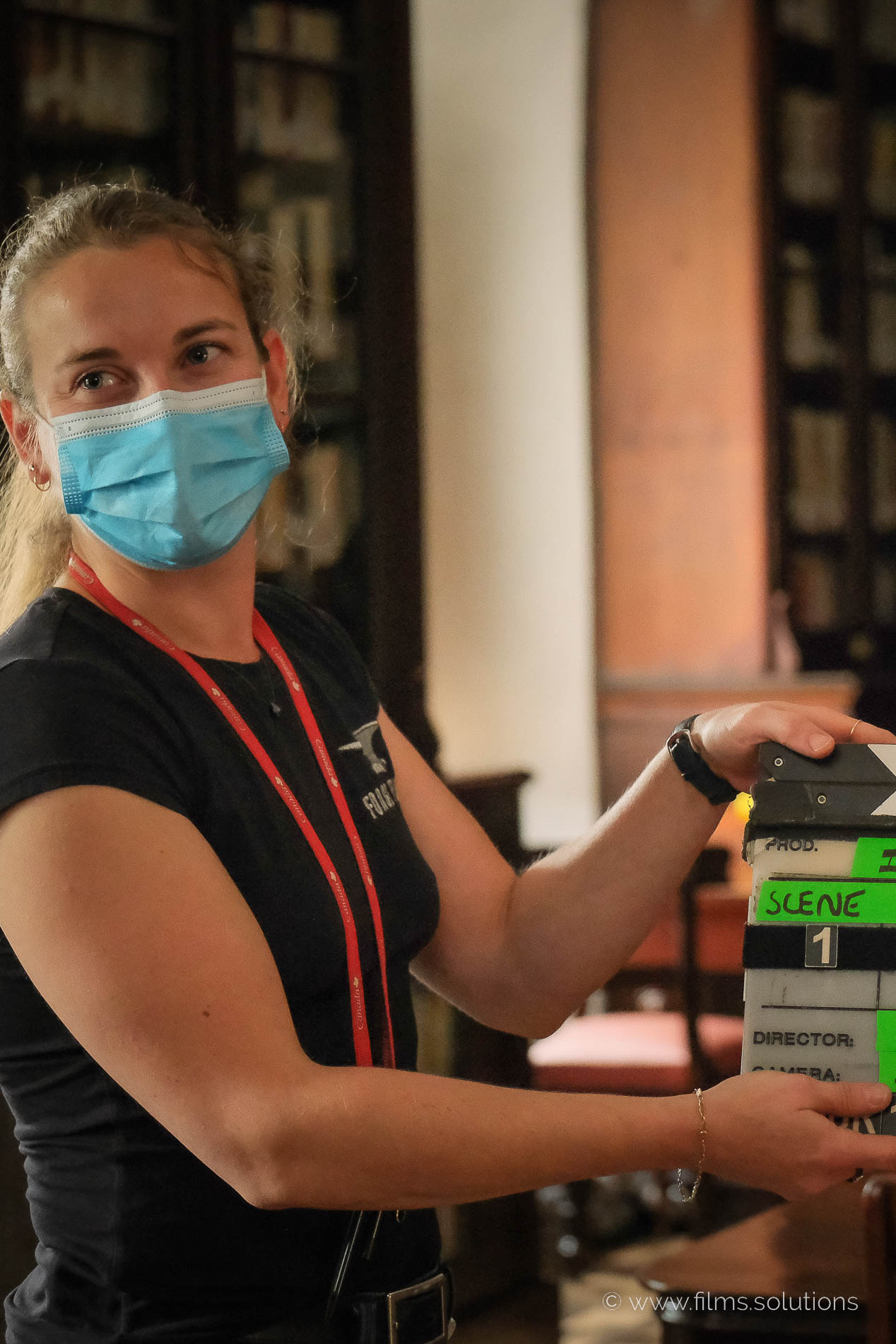 Emilie, a vital member of Films.Solutions, clapping the next scene as Richard Duquette's camera assistant on the set of "Les 12 Travaux d'Imelda."