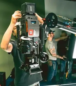 Camera crew setting up camera on crane for vertical shots, professionally coordinated by Films.Solutions.