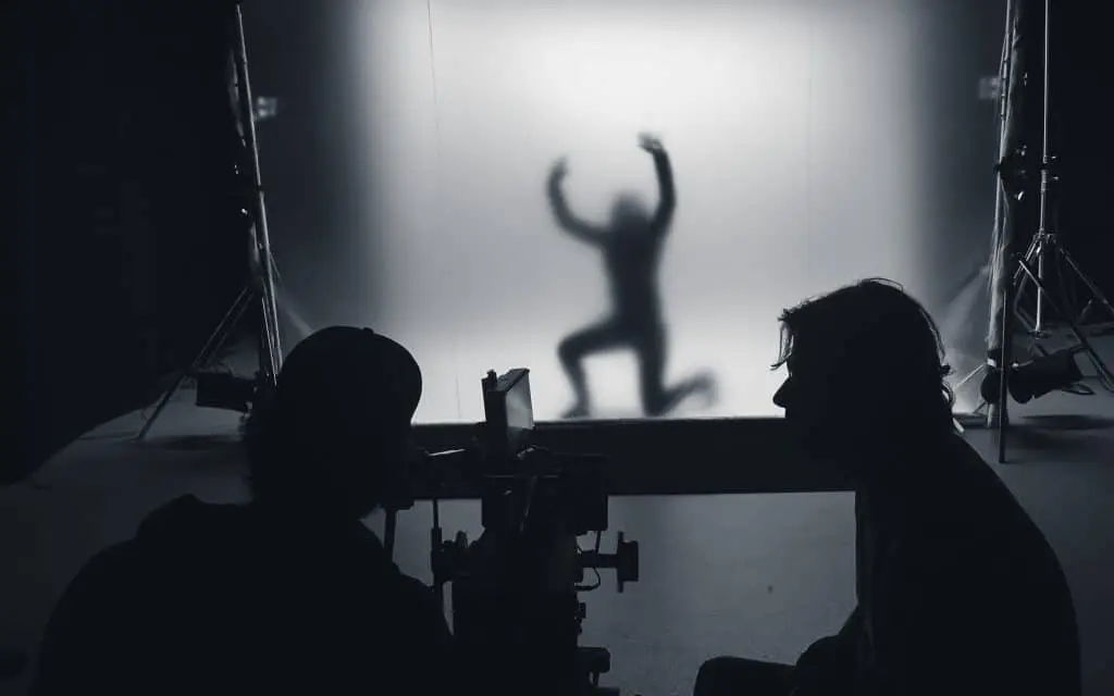 DOP, camera, 1AC in the foreground, with Films.Solutions assistant behind a large diffusion screen, prepping for U2's 2018 tour video shoot