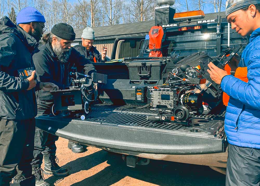 Luka, our camera specialist, tending to the camera on the tailgate of a pickup truck with the American crew during a production in GooseBay, Labrador.
