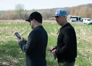 The director attentively observes the local drone operator, hired by Films.Solutions, as they film the original crime scene from 1979.