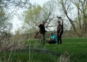 The director, DOP, and an assistant camera operator intently discussing and visualizing the next scene's filming.