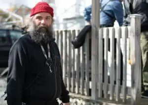 Luka, the first assistant camera, gazing towards the photographer while donning his signature red tuque during the "Citizen Detective" series production.