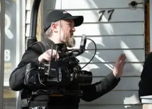 The Director of Photography, engaged in conversation while wearing an Easy-RIG with the camera attached, during the "Citizen Detective" shoot.