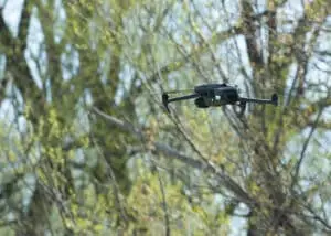 A close-up view of a drone, hovering above the historical crime scene.