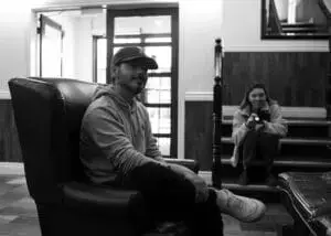 Billy, an Inuk artist, in discussion about the upcoming shoot in a hotel lobby in Goose Bay, with the client liaison officer in the background