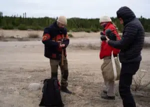 Billy wearing a FAY jacket getting ready for the shoot, with Vitoria, the liaison officer, and Marco, the cinematographer, in the scene