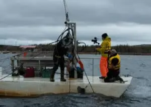 Director and cinematographer filming the brothers, wearing FAY jackets, on a barge bringing scallops to the surface