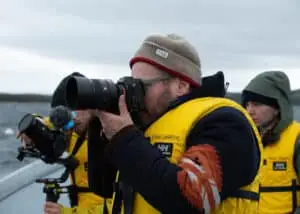 Close-up of the director in a yellow safety jacket, taking pictures for FAY jacket’s next season