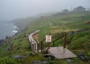 An old boardwalk in the village of Grate Cove, enveloped in foggy and rainy weather