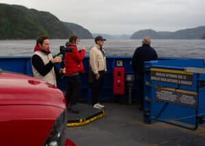 Film team including the cinematographer, liaison officer, Richard the Fixer, and the Director on a ferry crossing the Saguenay River, Québec