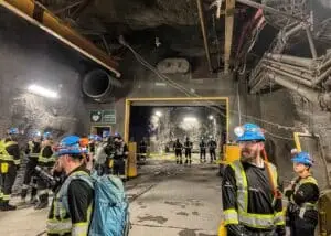 Film crew amidst the vast expanse of the mine's subterranean landscape.