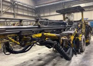 A massive drill poised in the garage, ready to delve back into the depths.