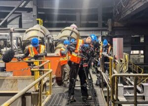 Filming crew on a passerelle capturing various sections of the mineral processing sequence at the mine.