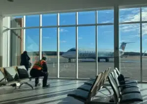 Production crew arriving at Rouyn-Noranda Airport, with Air Canada plane in the background.