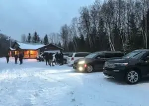 Film crew and production vehicles gathered at the entrance of Parc d'Aiguebelle, ready to commence filming.