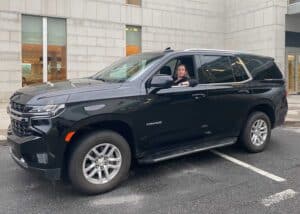 Emilie from Films.Solutions smiling in a black SUV at Quebec Airport